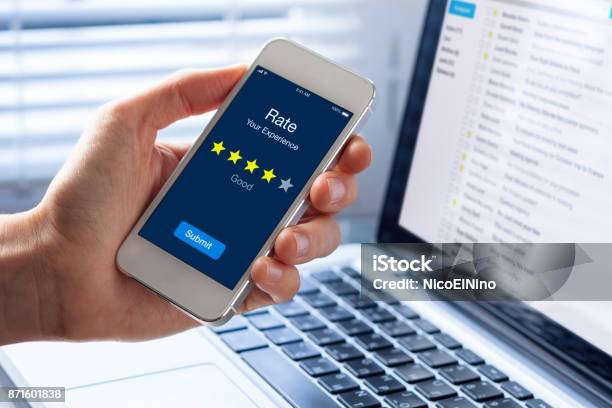 Person Rating His Experience With Stars On Smartphone App Screen Stock Photo - Download Image Now