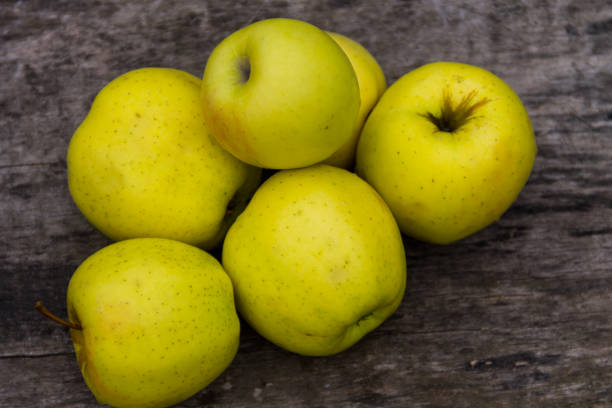 istock Ripe green apples on rustic wooden table 871601860