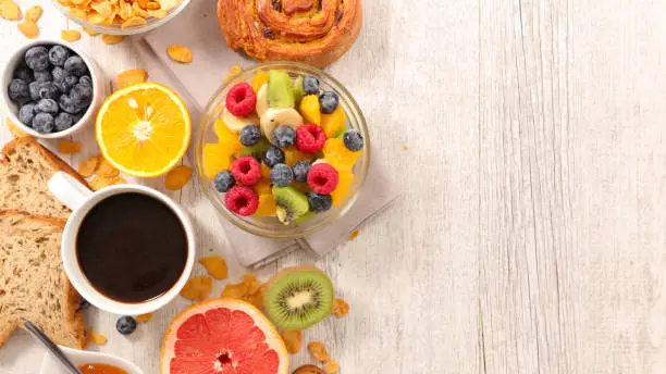Photo of fruit salad,coffee and croissant