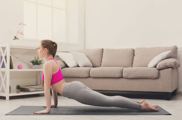 istock Woman training yoga in cobra pose. 871602514