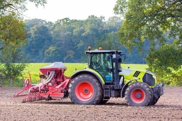 istock Tractor with agricultural machine on land 871604970