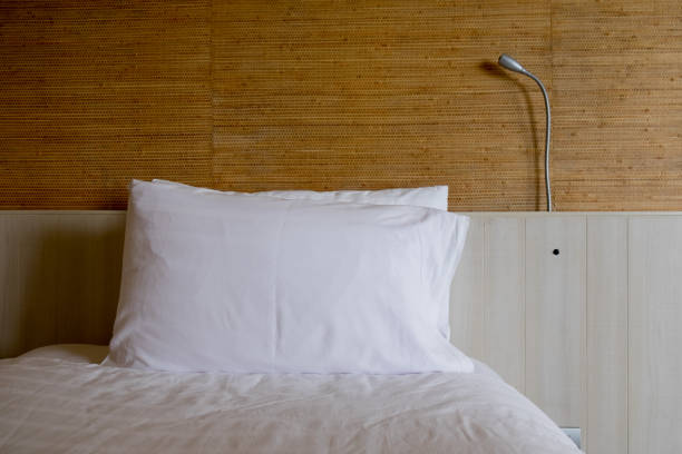 istock White bedding and pillow in hotel room 871606208