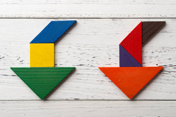 istock wooden tangram in two going down arrow shapes 871606534