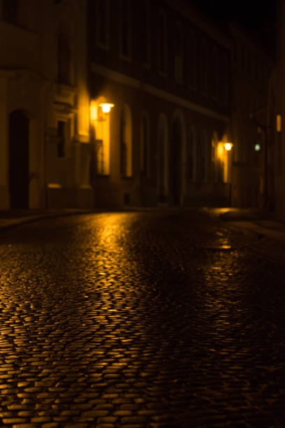 istock cobbled street in old city by night 871609458