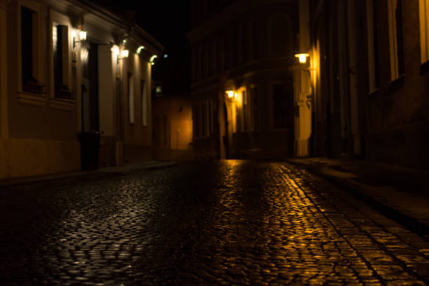 istock cobbled street in old city by night 871609500