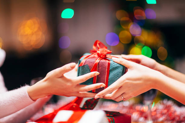 Hands Giving Gift Close-up Close-up photography of two hands while giving gift. passing giving stock pictures, royalty-free photos & images