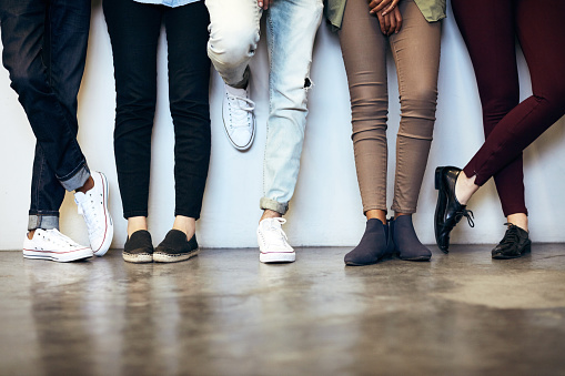 Cropped shot of unrecognizable university students in a campus corridor