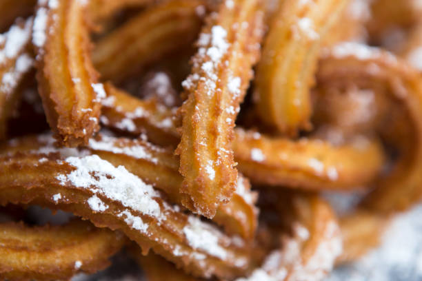 istock Churros with powdered sugar on plate, closeup 871621422