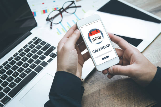 istock Businessman checking calendar on smartphone 871621916