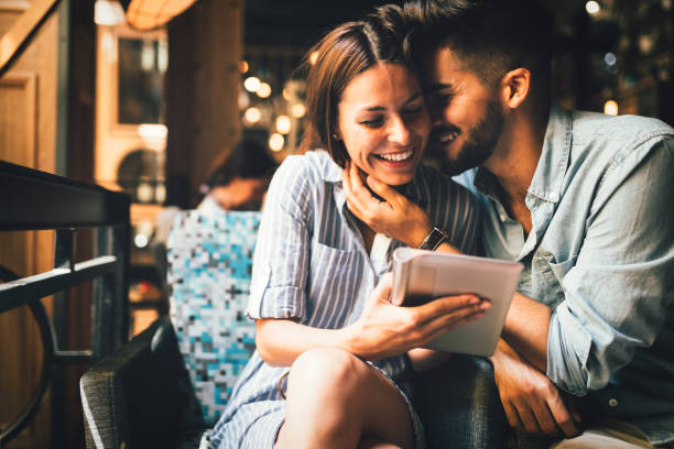 istock Young attractive couple on date in coffee shop 871625324