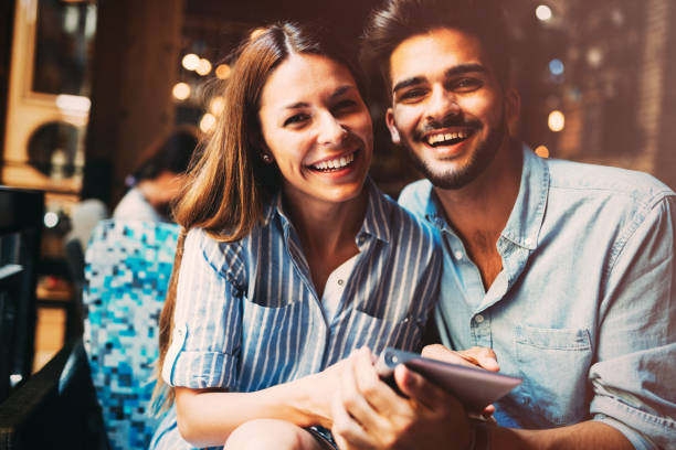 istock Young attractive couple on date in coffee shop 871625428