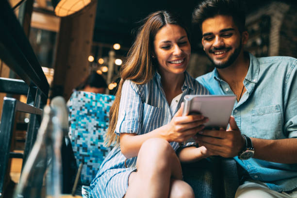 istock Young attractive couple on date in coffee shop 871625524