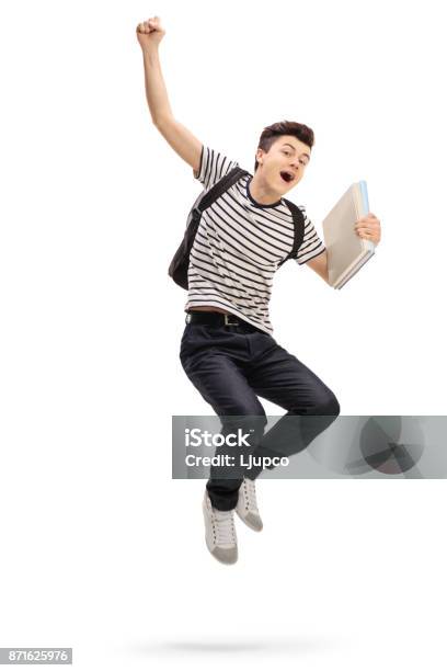 Overjoyed Teenage Student Jumping And Gesturing Happiness Stock Photo - Download Image Now