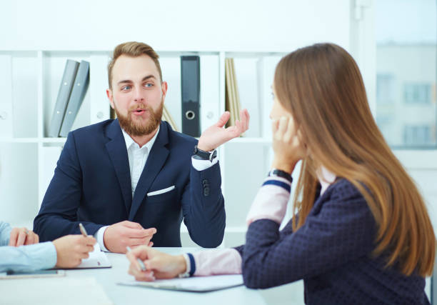istock Close-up of Businesspeople sitting at conference table. communicating. 871631936
