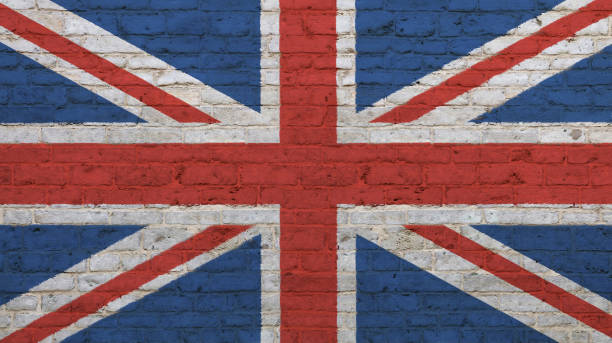 istock Old vintage UK British flag over brick wall 871632196