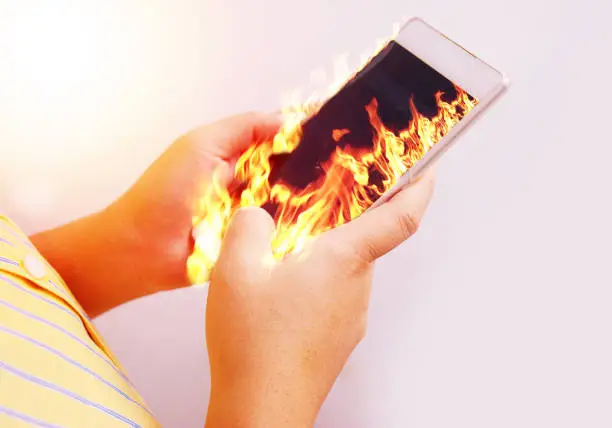 Photo of Fire hand hold fire smartphone.