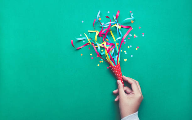 Celebration,party concepts.hand holding colorful confetti,streamers.