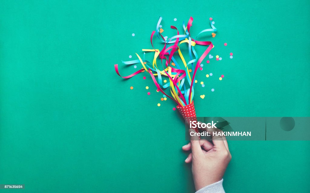 Celebration,party concepts.hand holding colorful confetti,streamers. Celebration,party backgrounds concepts ideas with hand holding colorful confetti,streamers.Flat lay design Confetti Stock Photo