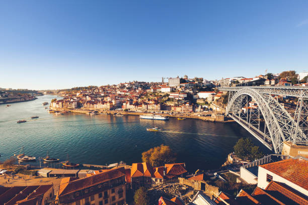 porto city, portugal oporto city with douro river and dom luiz bridge under blue sky, portugal. portugal photos stock pictures, royalty-free photos & images