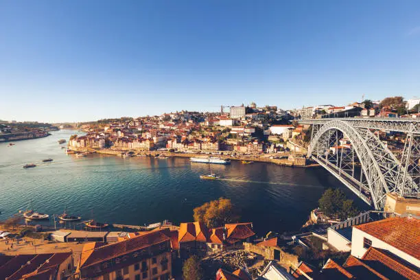 oporto city with douro river and dom luiz bridge under blue sky, portugal.