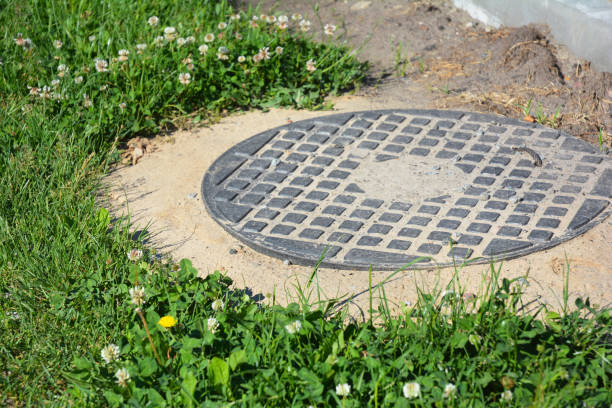 istock Manhole cover installation in the garden. 871641334