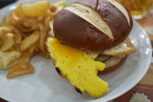 istock Pretzel sandwich with fried eggs and fries 871641570