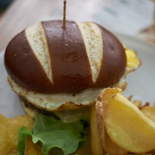 istock Pretzel sandwich with fried eggs and fries 871641622