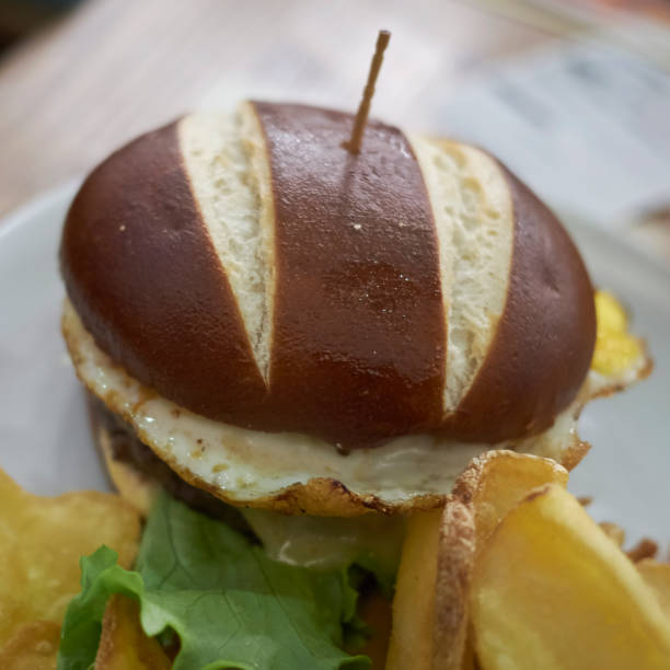 istock Pretzel sandwich with fried eggs and fries 871641628