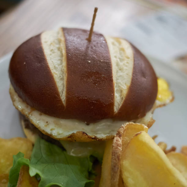 istock Pretzel sandwich with fried eggs and fries 871641652