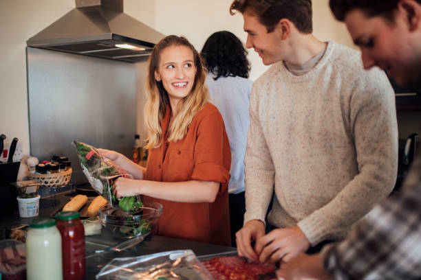 istock Group of Friends Cooking at Home 871644950
