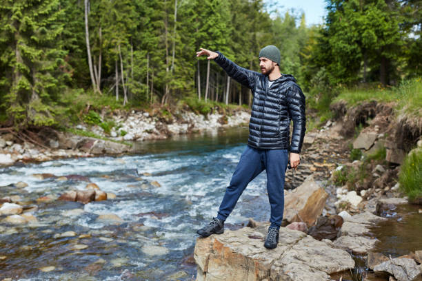 istock Young man pointing travel direction 871645684