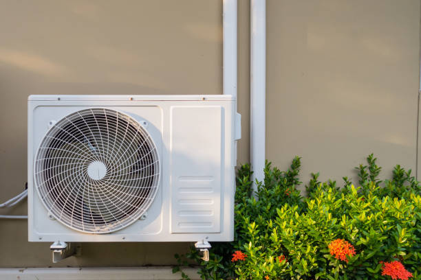 air conditioning system installation embedded on wall of building - condenser imagens e fotografias de stock