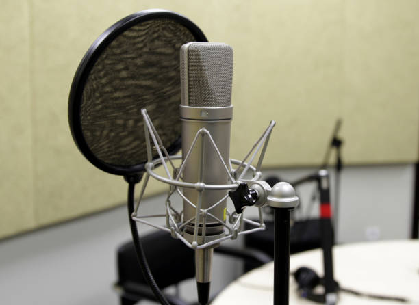 istock Professional condenser studio microphone over the musician blurred background and audio mixer, Musical instrument Concept. 871652348