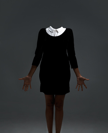 Studio shot of a headless woman against a grey background