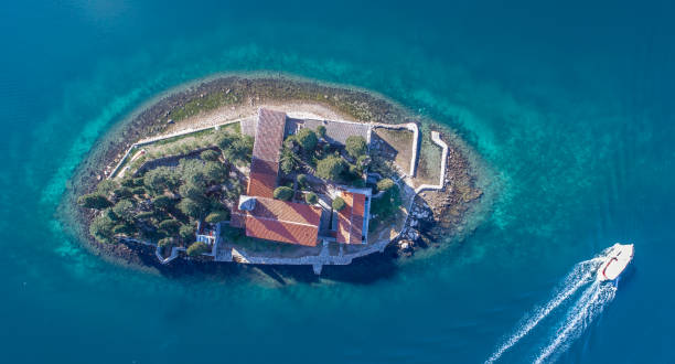 istock Boat passing by island monastery St. George in Perast 871660042