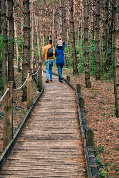 istock A young couple walks with a little boy 871661776