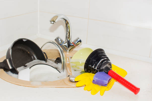 huge heap of dirty dishes waiting for the flatmate huge heap of dirty dishes waiting for the flatmate. a clog in the kitchen sink flatmate stock pictures, royalty-free photos & images