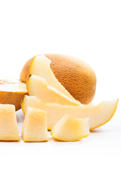 istock Whole, half and sliced honeydew melon tropical fruit on white 871666884