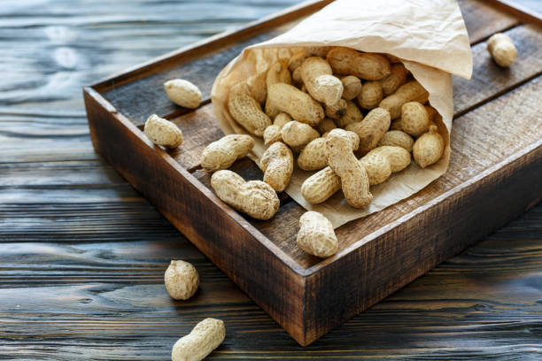 istock Paper bag with unshelled peanuts. 871669266