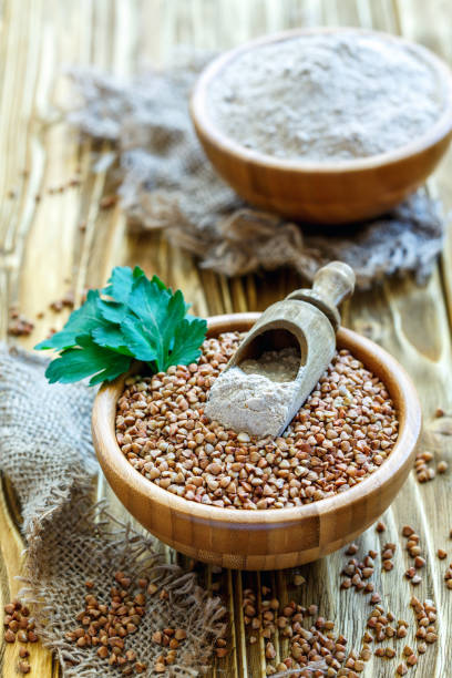 istock Scoop with buckwheat flour in a bowl with buckwheat. 871671848