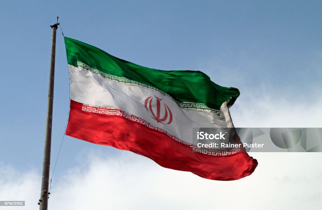 Giant Iranian Flag in the wind A big flag of Iran waving in the wind in Tehran, Iran. Iran Stock Photo
