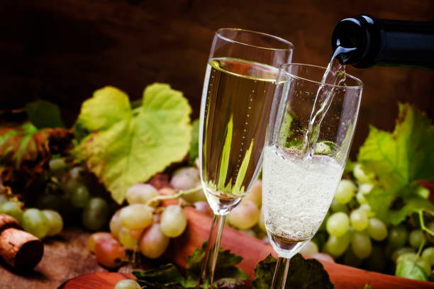 istock Champagne Pour In Glass, Grapes With Vine 871675466