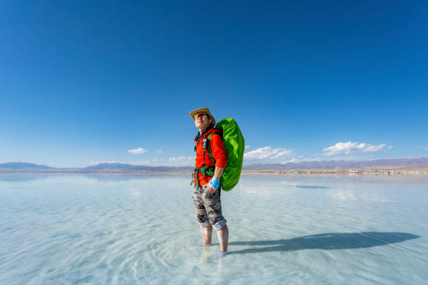 istock Young man standing in the Chaka Salt Lake 871675836