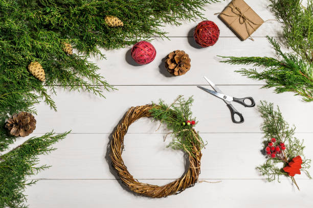 istock How to make christmas door wreath. The working process. The decorator's workplace. Top view 871679500
