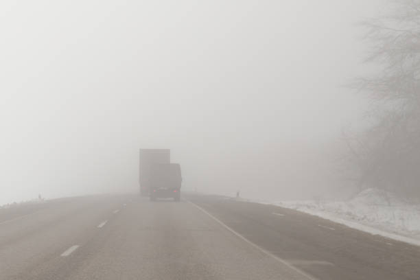 istock trucks on a foggy road 871679900