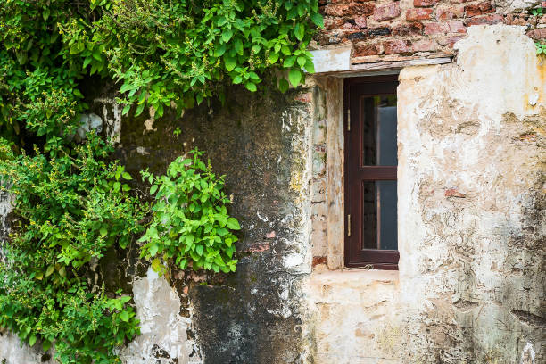 istock Old house with a wooden window. 871680372