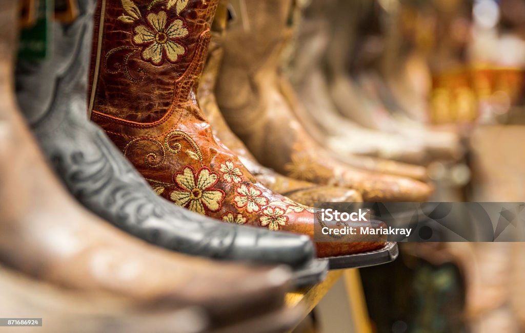 Close-up of new cowboy boots on shelf Close-up of new cowboy boots on shelf in a storeClose-up of new cowboy boots on shelf in a store Store Stock Photo