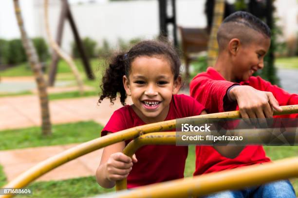 Siblings Playing On Roundabout Stock Photo - Download Image Now - Child, Playground, Brazil