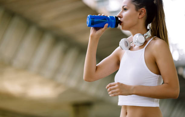 istock Portrait of woman taking break from jogging 871692408