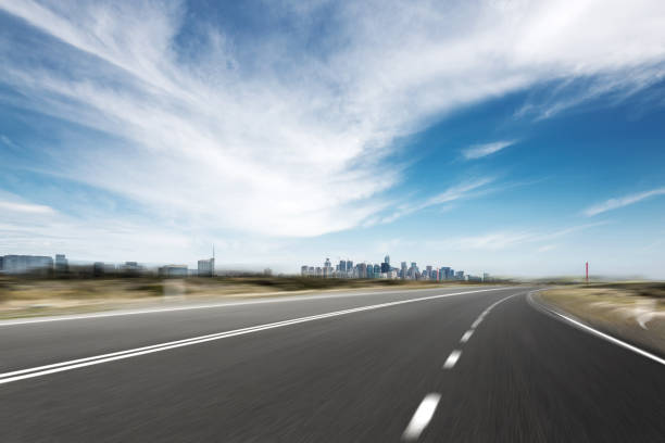 istock empty asphalt road with modern bridge and buildings 871692476